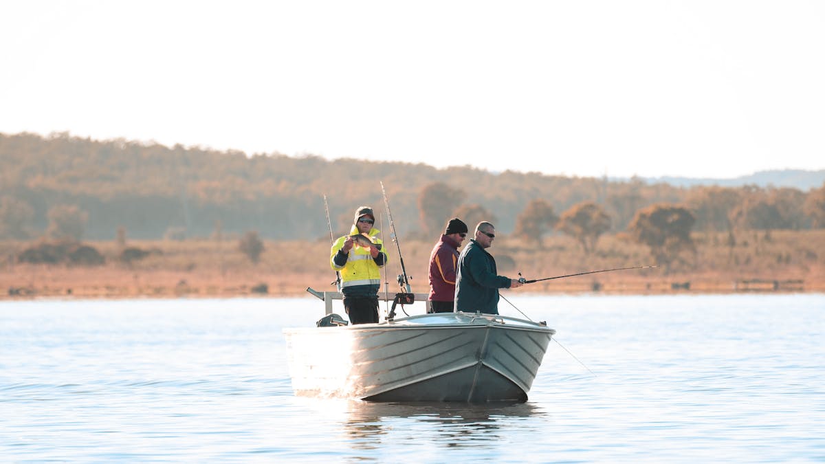 Fishing from a boat at Coolmunda Dam with the hills in the background