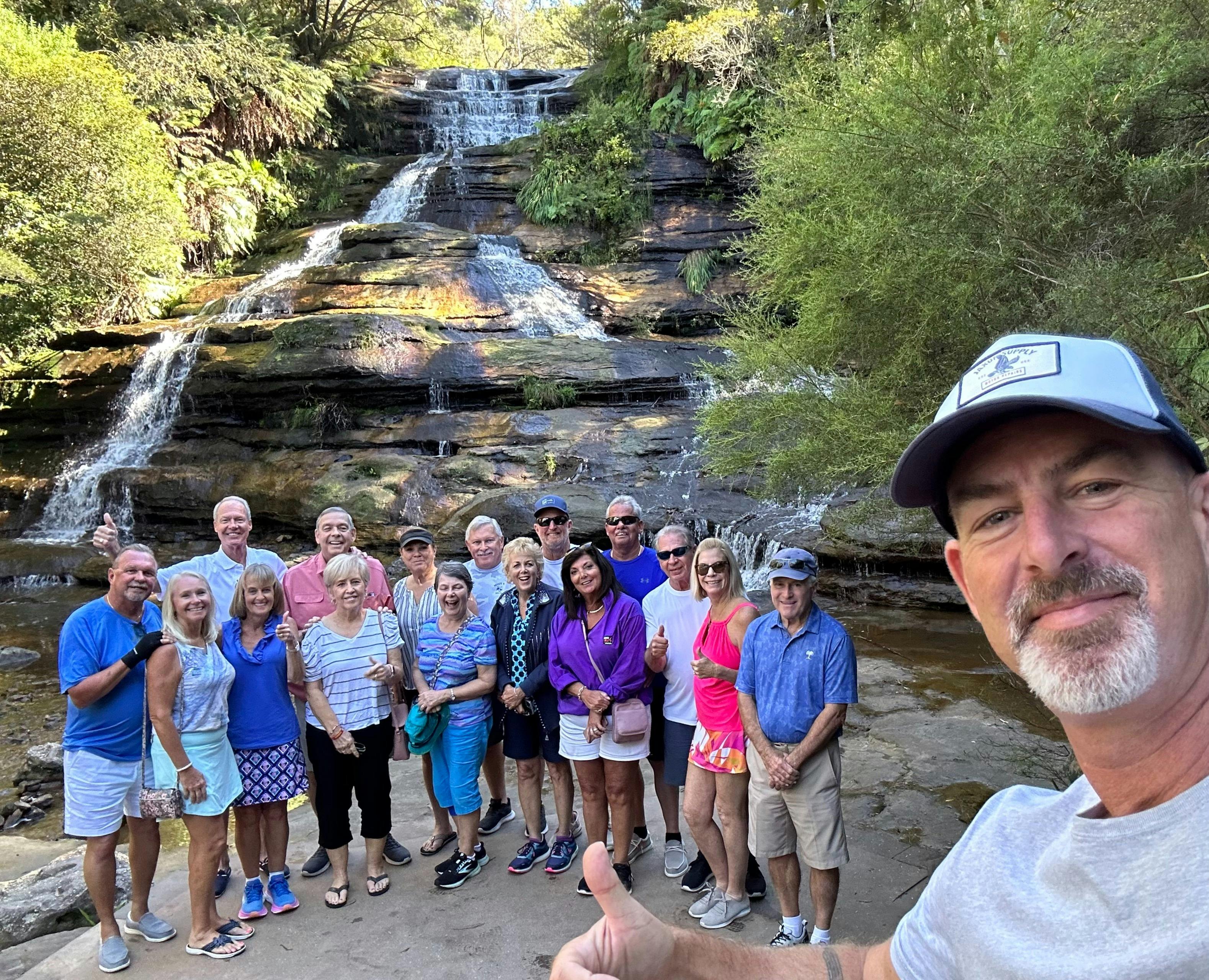 Tour guide Sean with a tour group  at a hidden waterfall in the Mountains