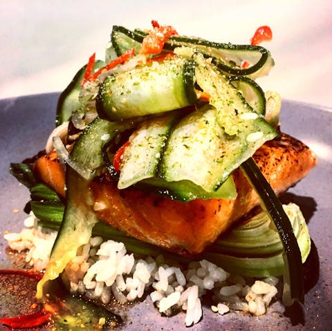 Miso glazed salmon, sushi rice, but choy, pickled cucumbers