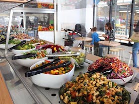 Bowls of salad on long counter