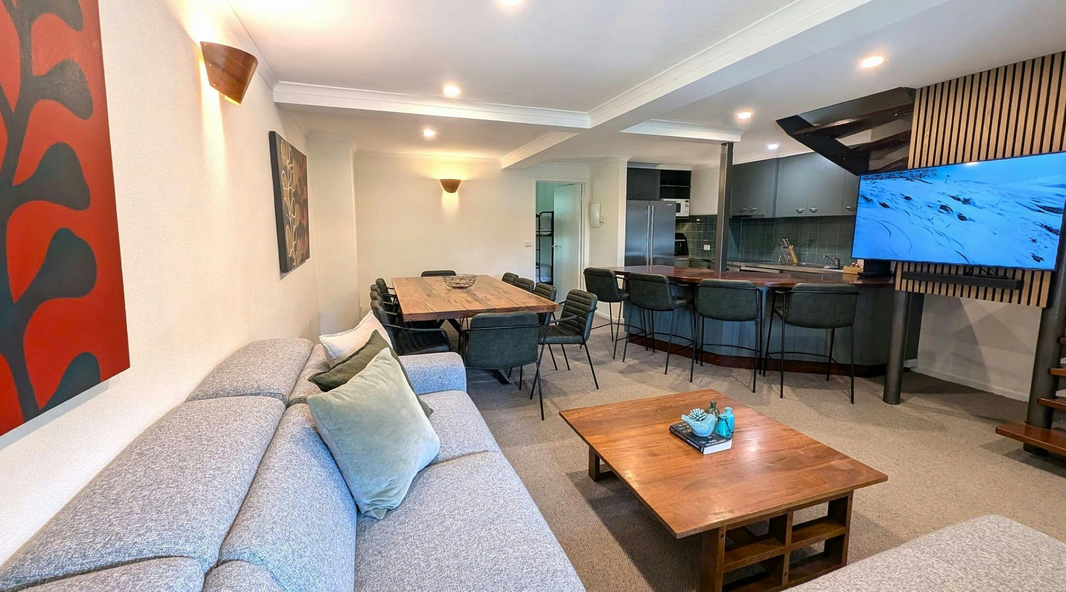 Living room space with couches, tea tables, television, table and chairs