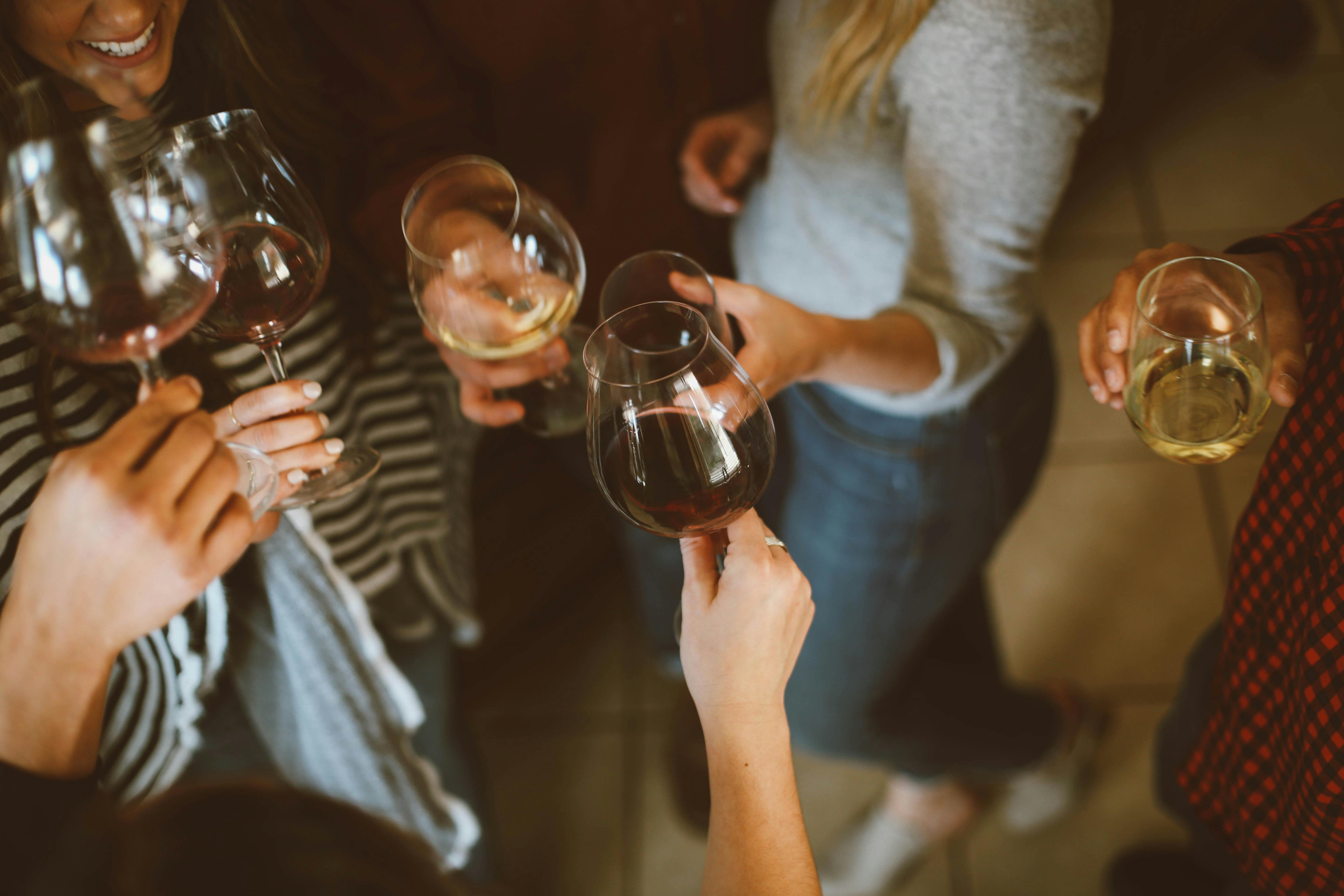Group of girls drinking red and white wine
