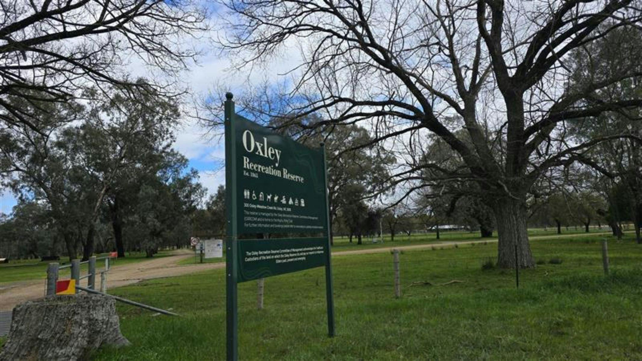 Oxley Recreation Reserve written on a green sign on green grass