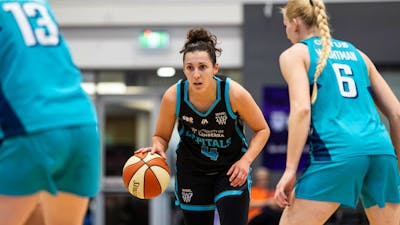 Basketball player bounces the ball.