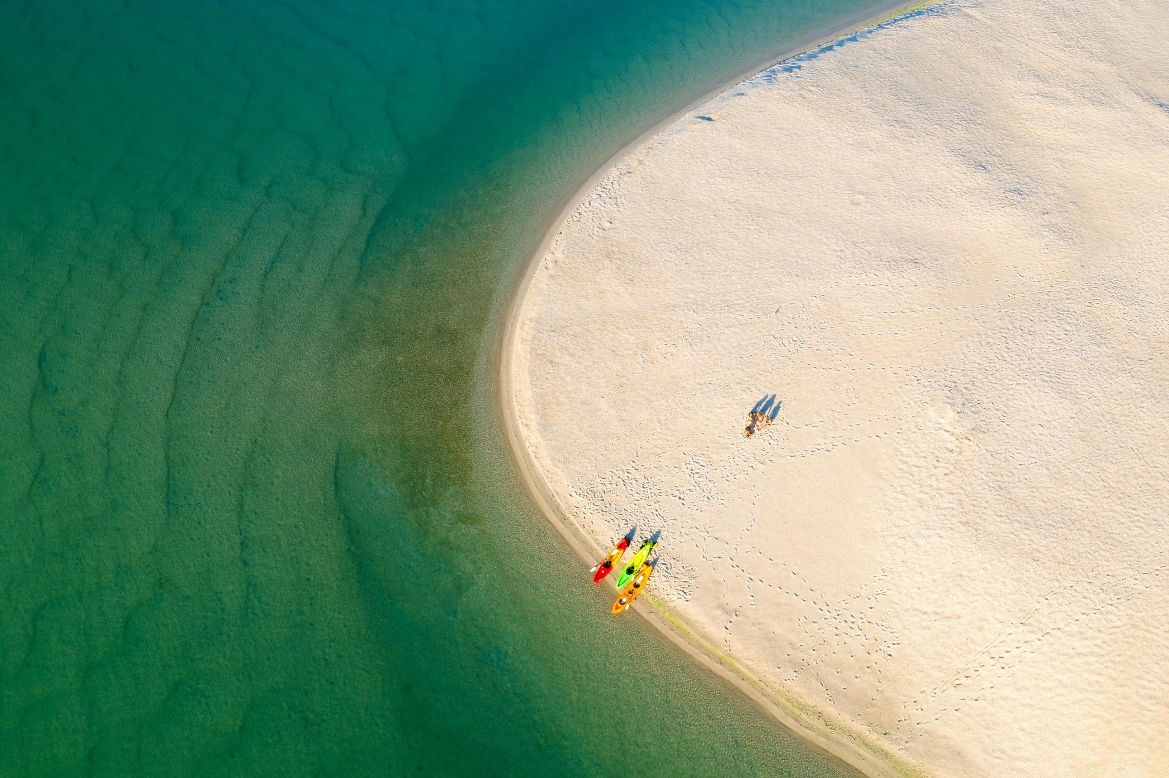 Friends enjoying a day of kayaking on Lake Maquarie off Naru Beach