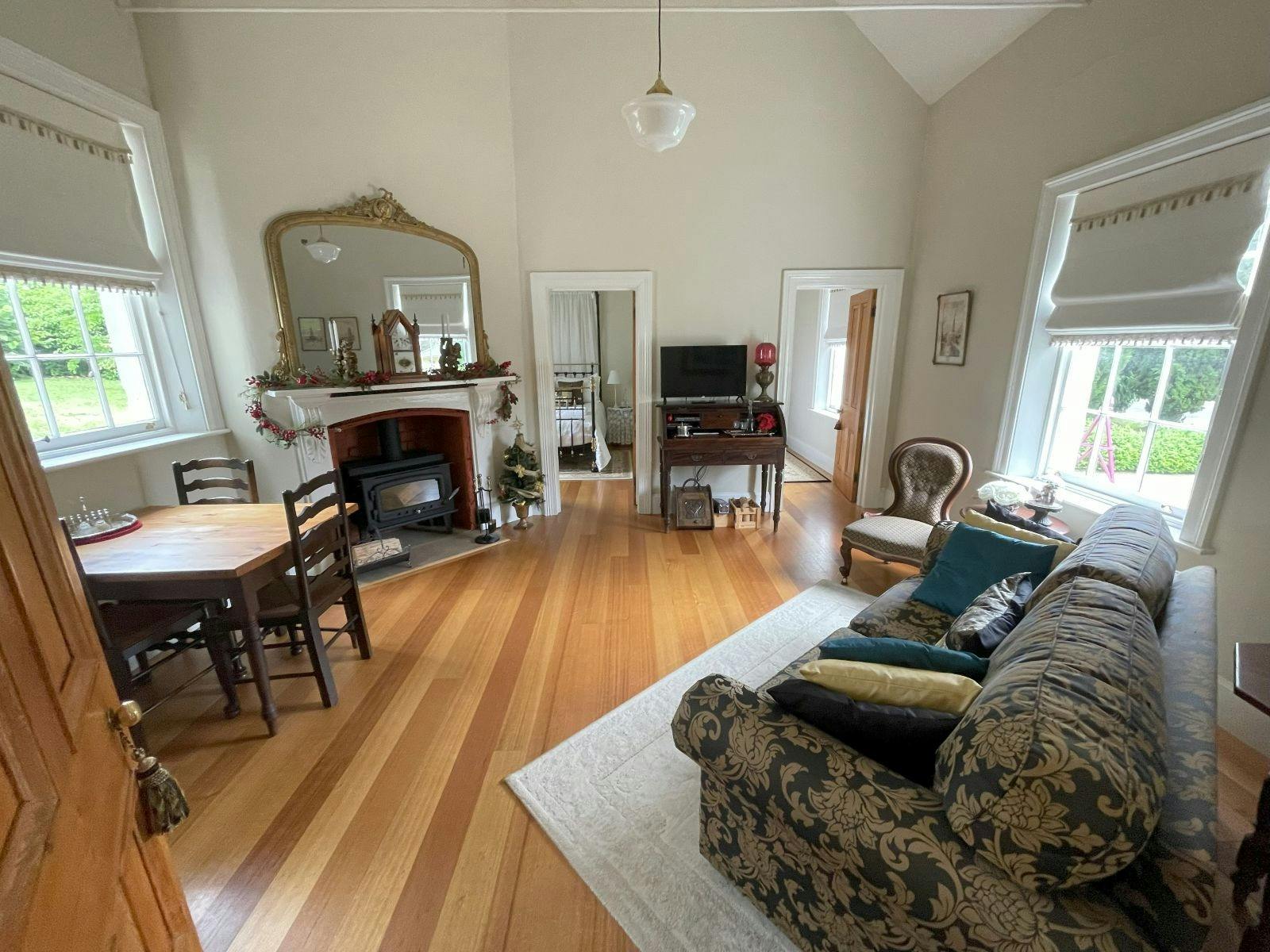 Themed living room including fireplace, TV with Netflix, lounge and dining table