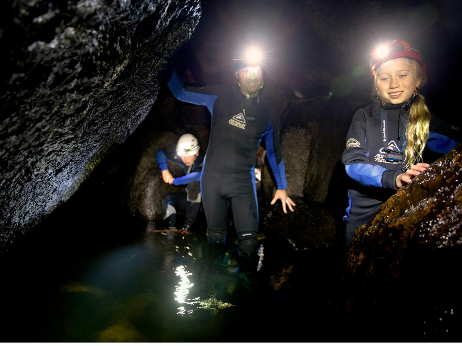 Walking in wetsuits through rock pools