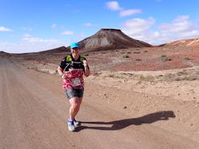 runner with desert hills behind