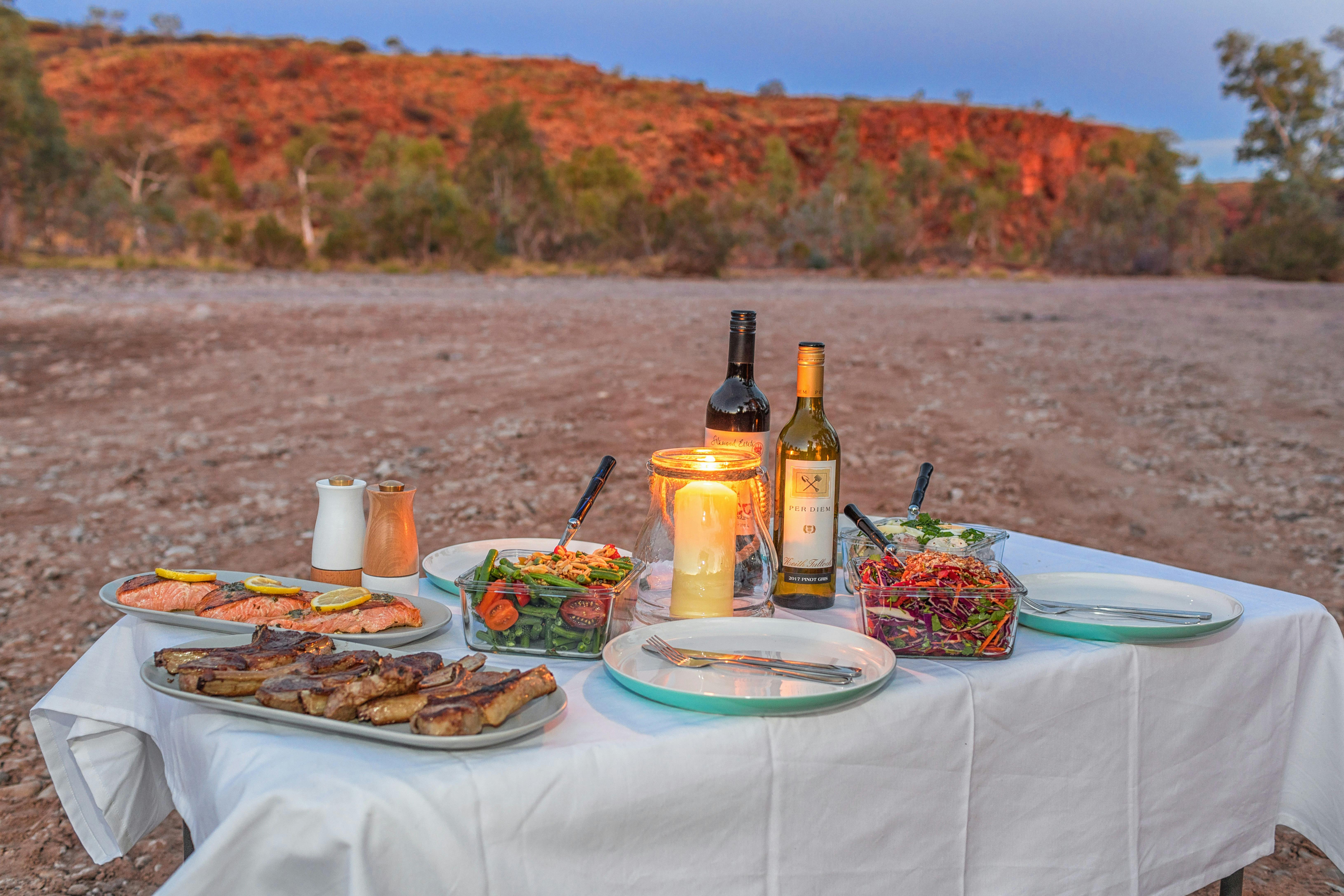 food on a table with mountains in background