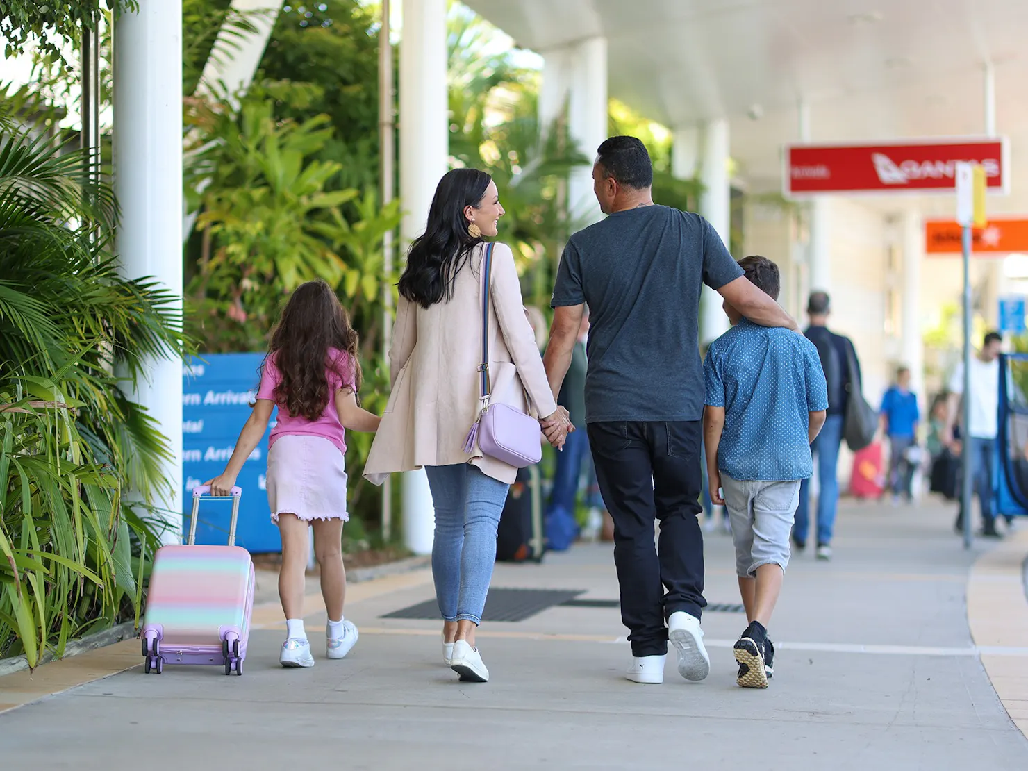 Photo of a family walking towards check-in from kerbside