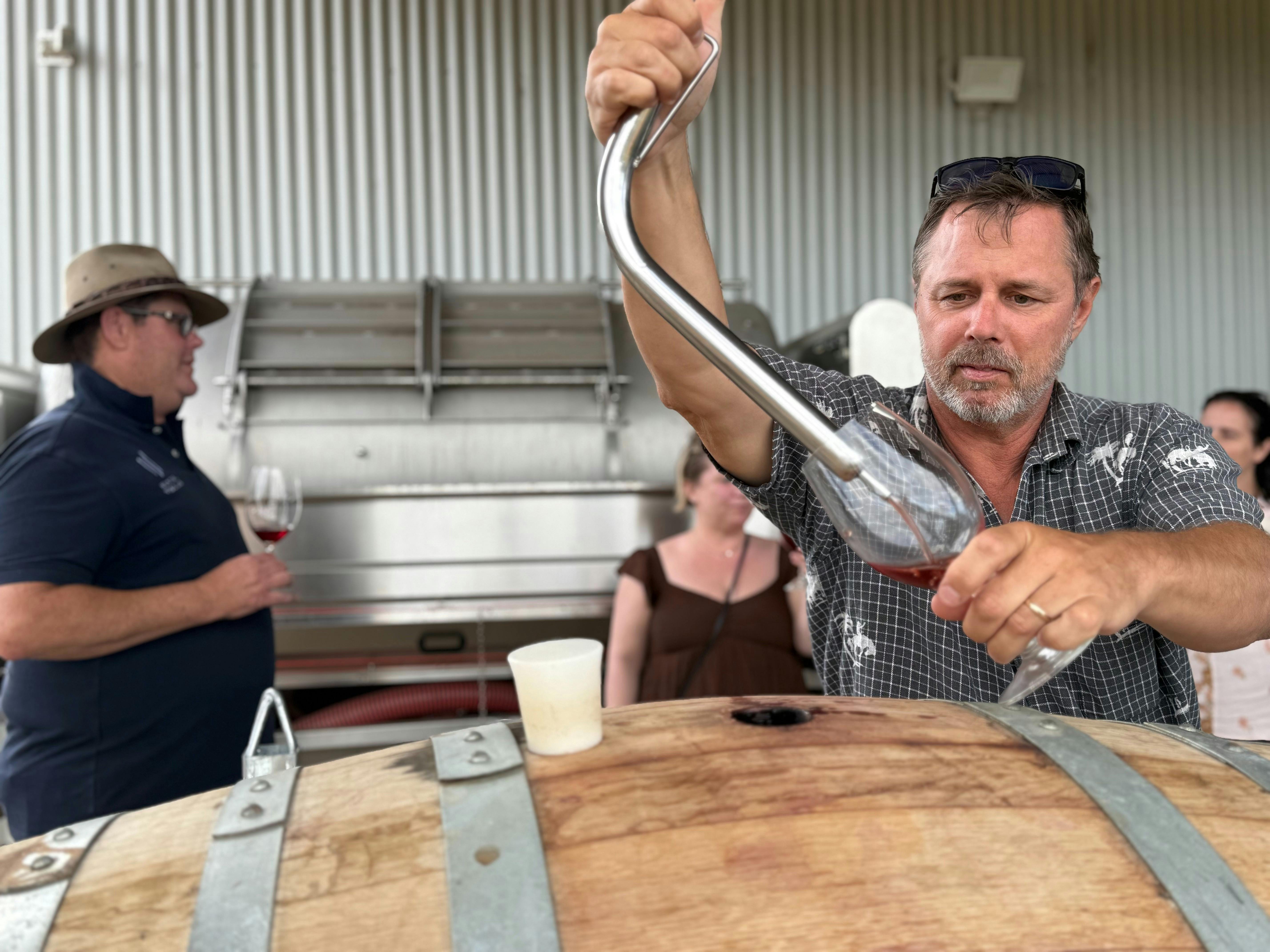 Winemaker pouring wine for guests during a barrel tasting at Hunter Wine Lab.