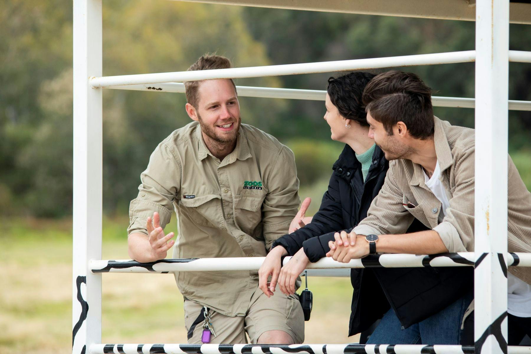A park ranger tour guide speaking to visitors in a bus