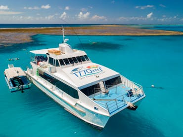 Large power catamaran sitting inside turquoise waters of Lady Musgrave Lagoon Large power catamaran sitting inside turquoise waters of Lady Musgrave Lagoon