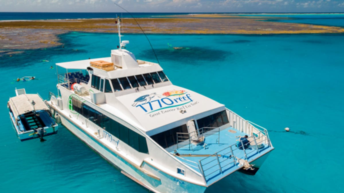 Large power catamaran sitting inside turquoise waters of Lady Musgrave Lagoon