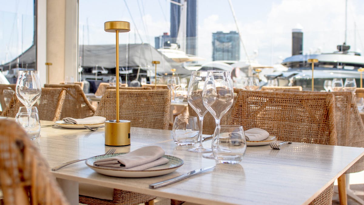 Restaurant dining at MĀRE overlooking yachts at Marina Mirage