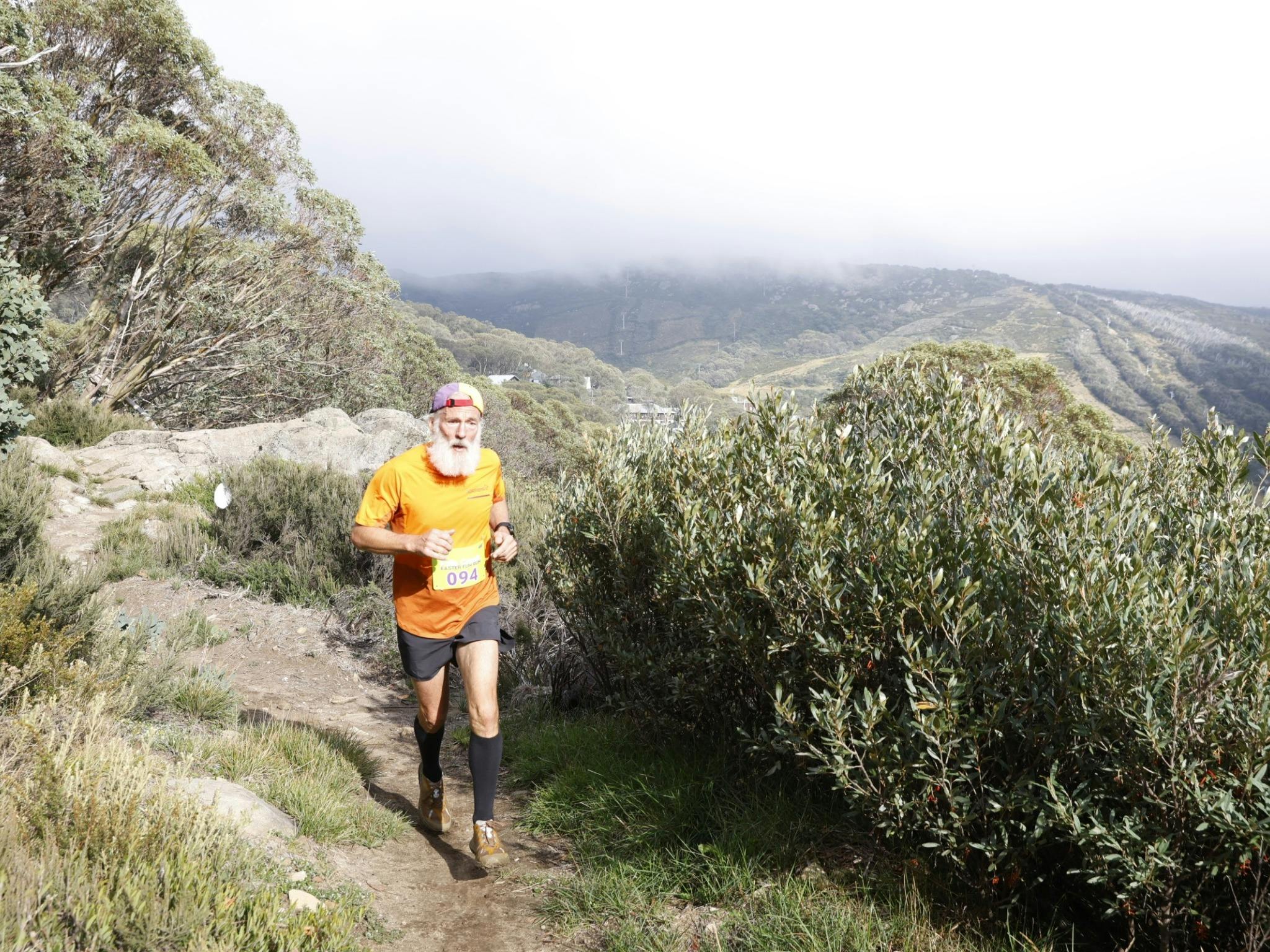 Single man running the mountain trail