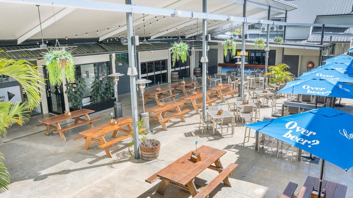 Spacious beer garden with outdoor tables and chairs at Reef Gateway Hotel