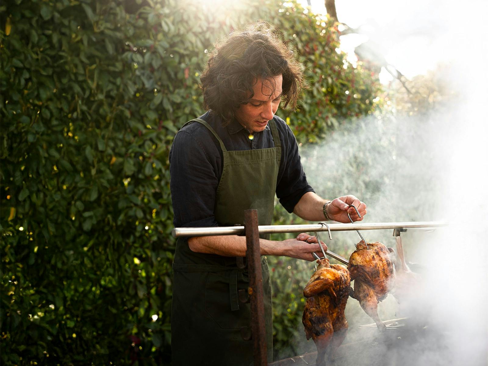 Kane cooking over coals