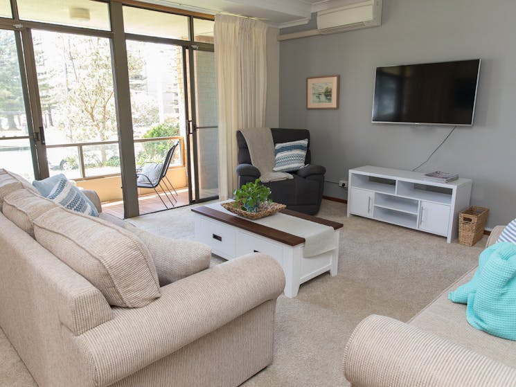 Taranaki Beach House | Opposite Town Beach - Lounge Room opens up to front porch