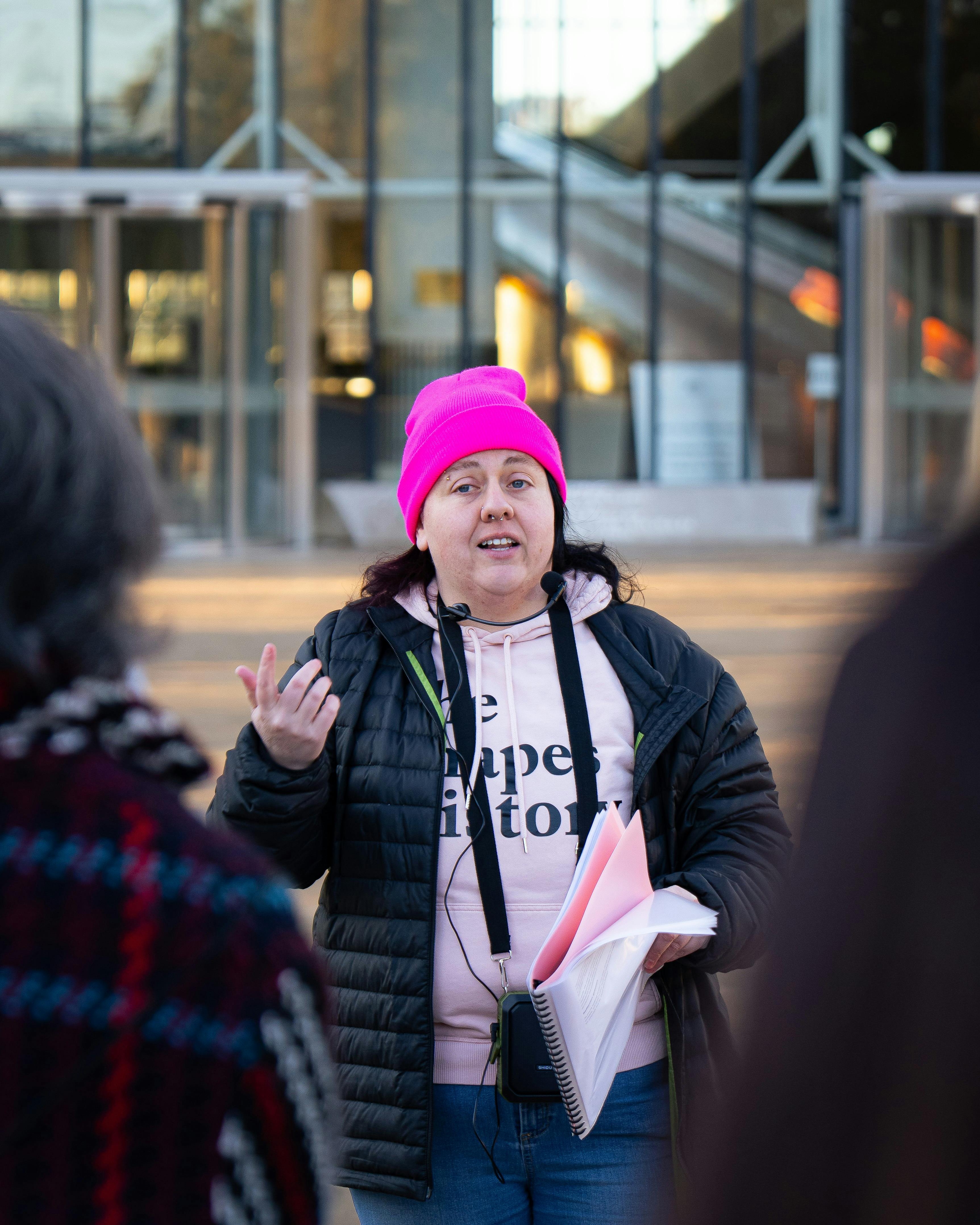 She Shapes History tour guide presenting to the group of engaged guests