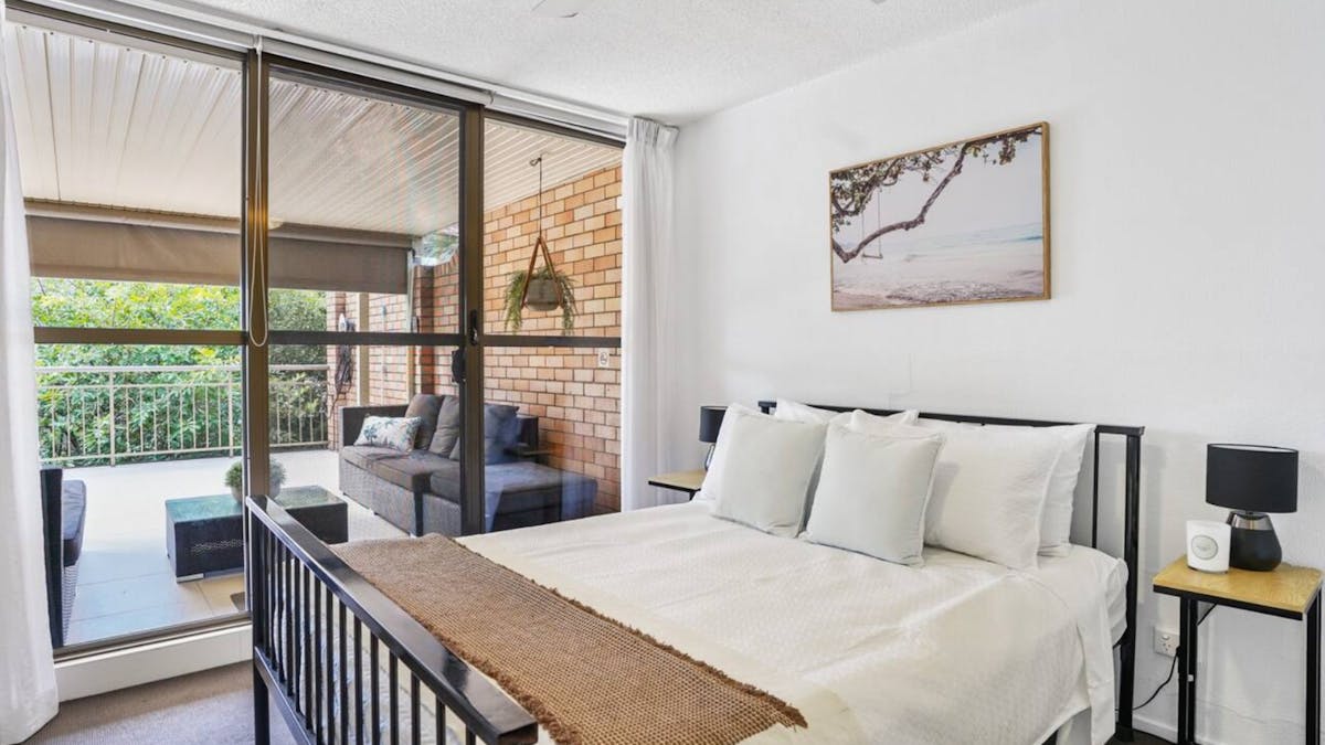 Main double bedroom with walk-in wardrobe and main balcony access
