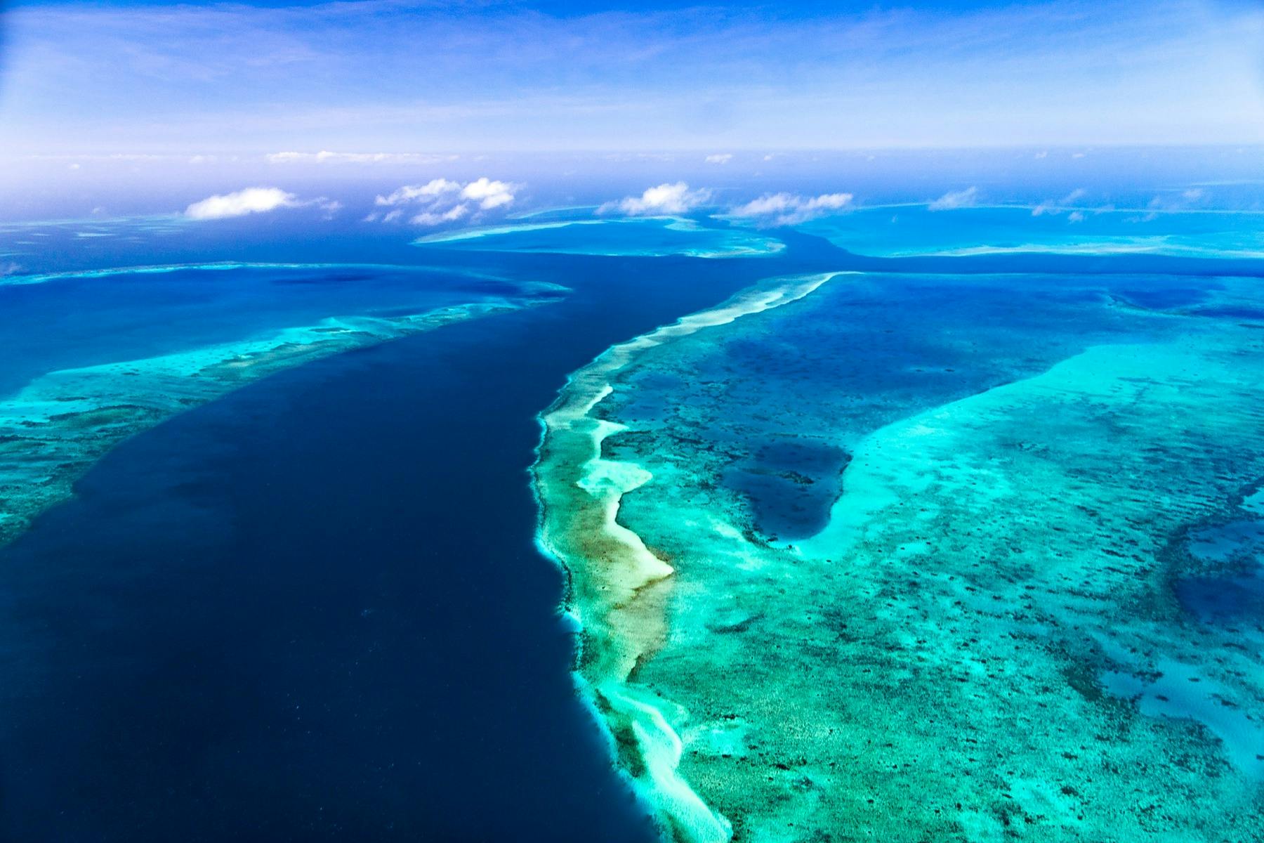 Aerial view of the crystal-clear waters, coral reefs and islands of the Torres Strait, Queensland.