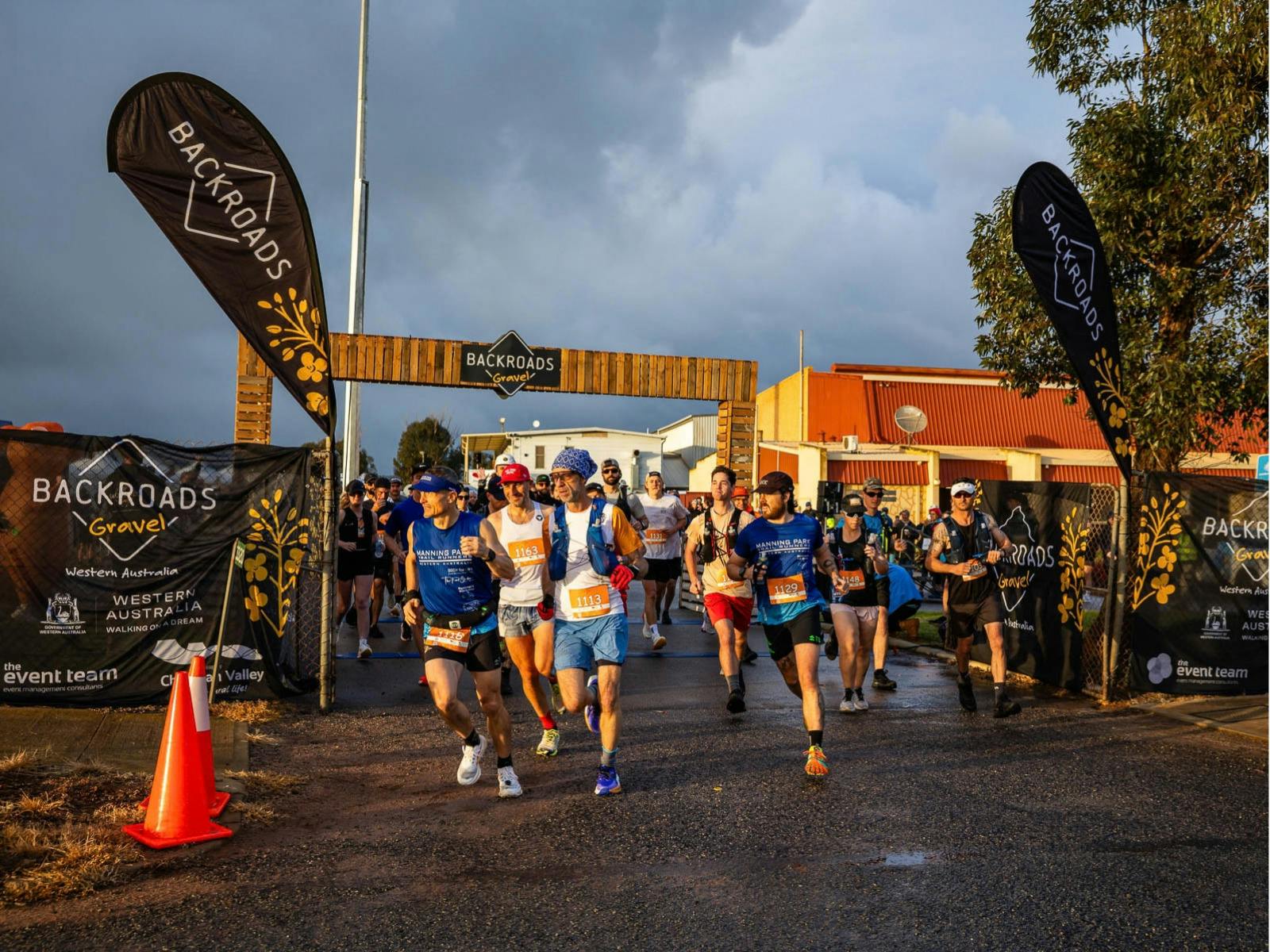 Runners starting their Backroads Gravel event beneath the start arch in Nabawa.
