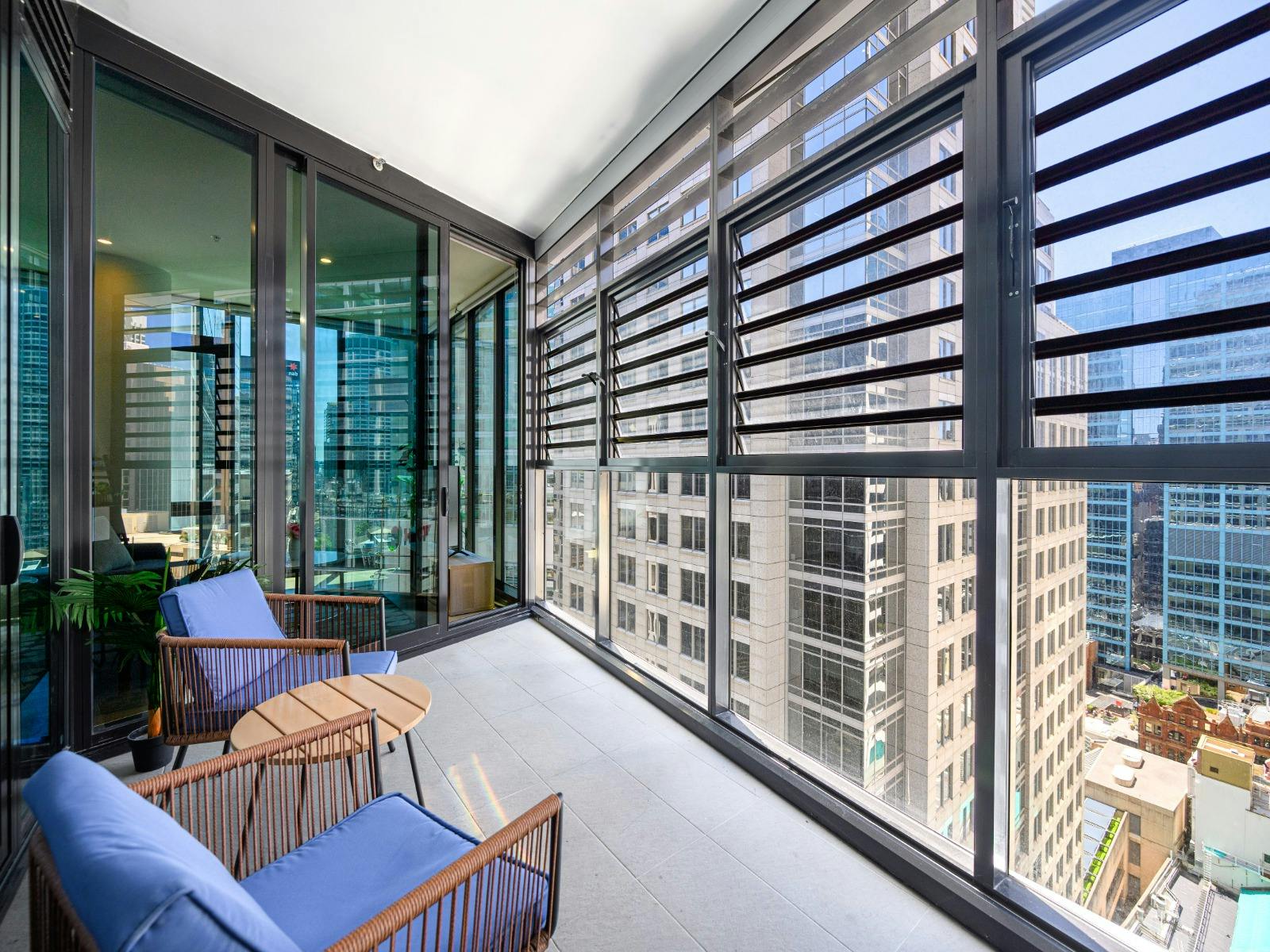 Balcony with outdoor seating and city views.