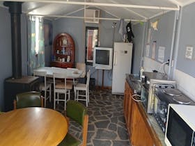 Cozy Kitchen with Moden Appliances & all your cooking needs, air-con, tv, wood fire & dining area.