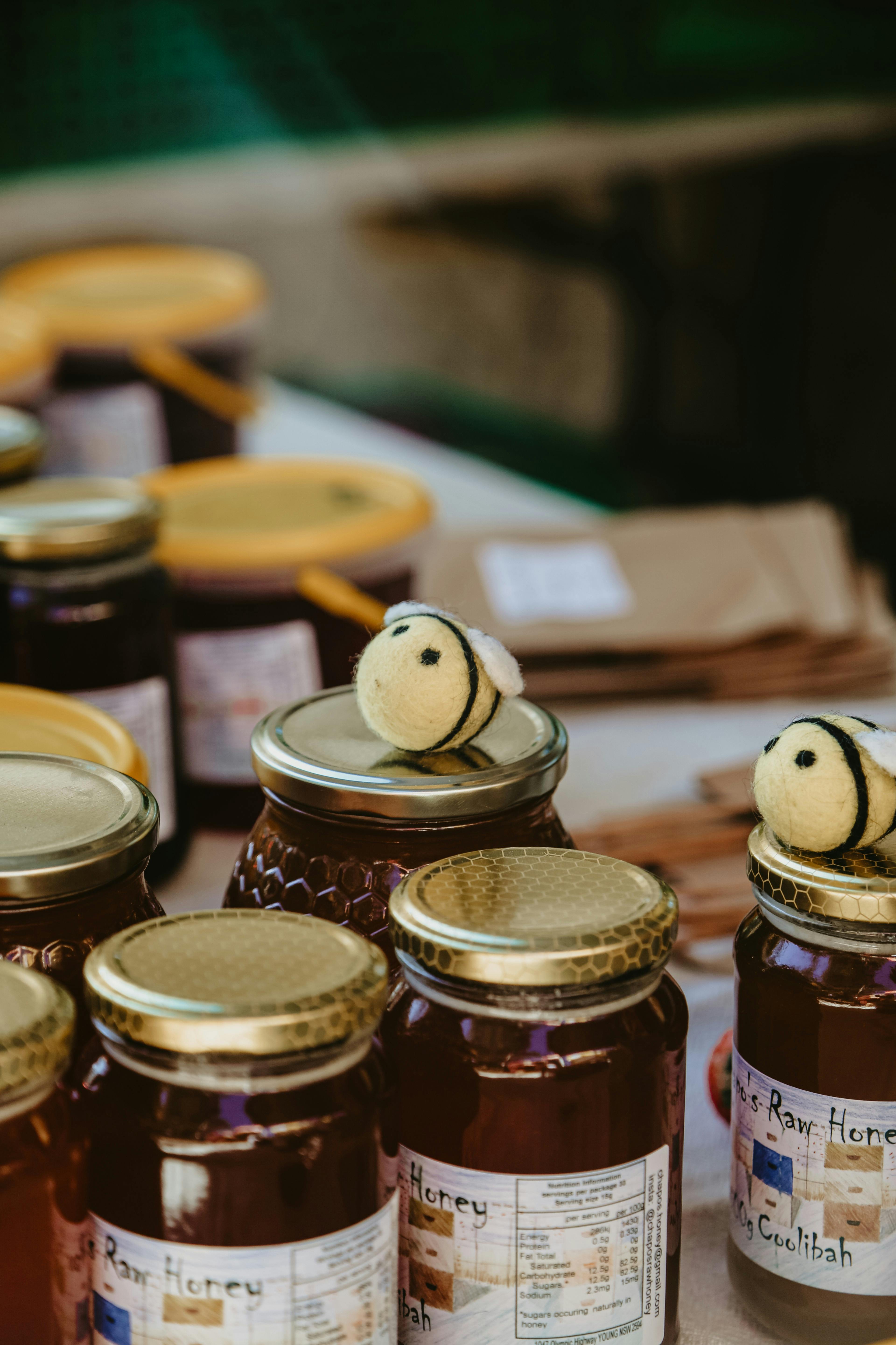 Bees on top of honey jars at Haig Park Vil