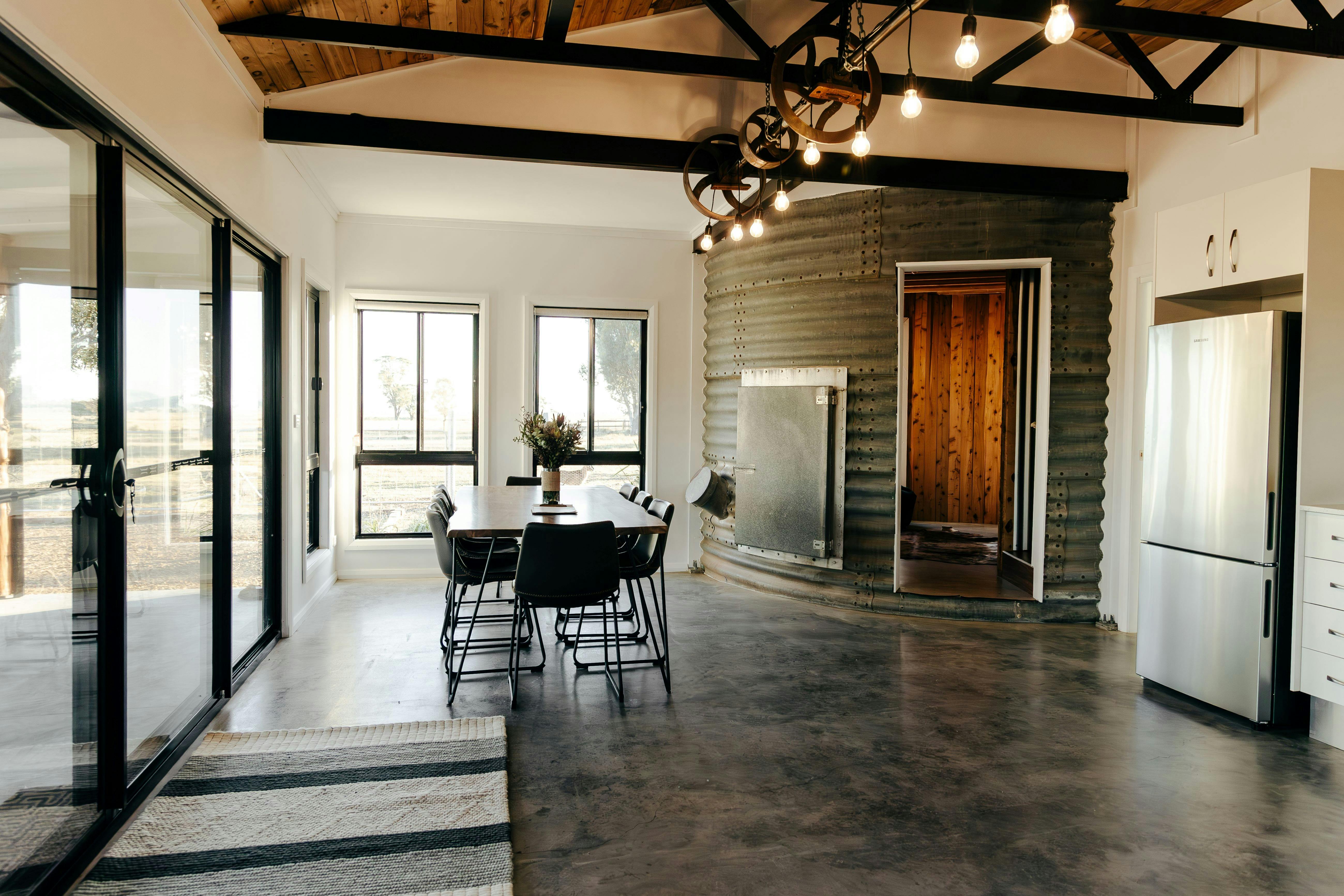 Large open plan kitchen/dining area with polished concrete floors
