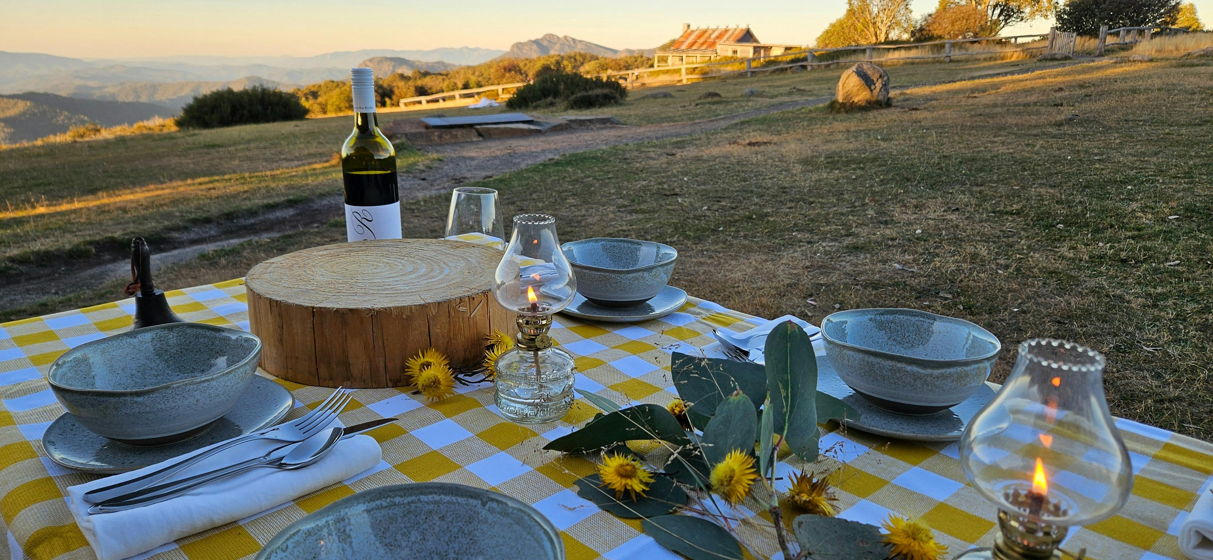 Table setting with Craig's Hut in the background.
