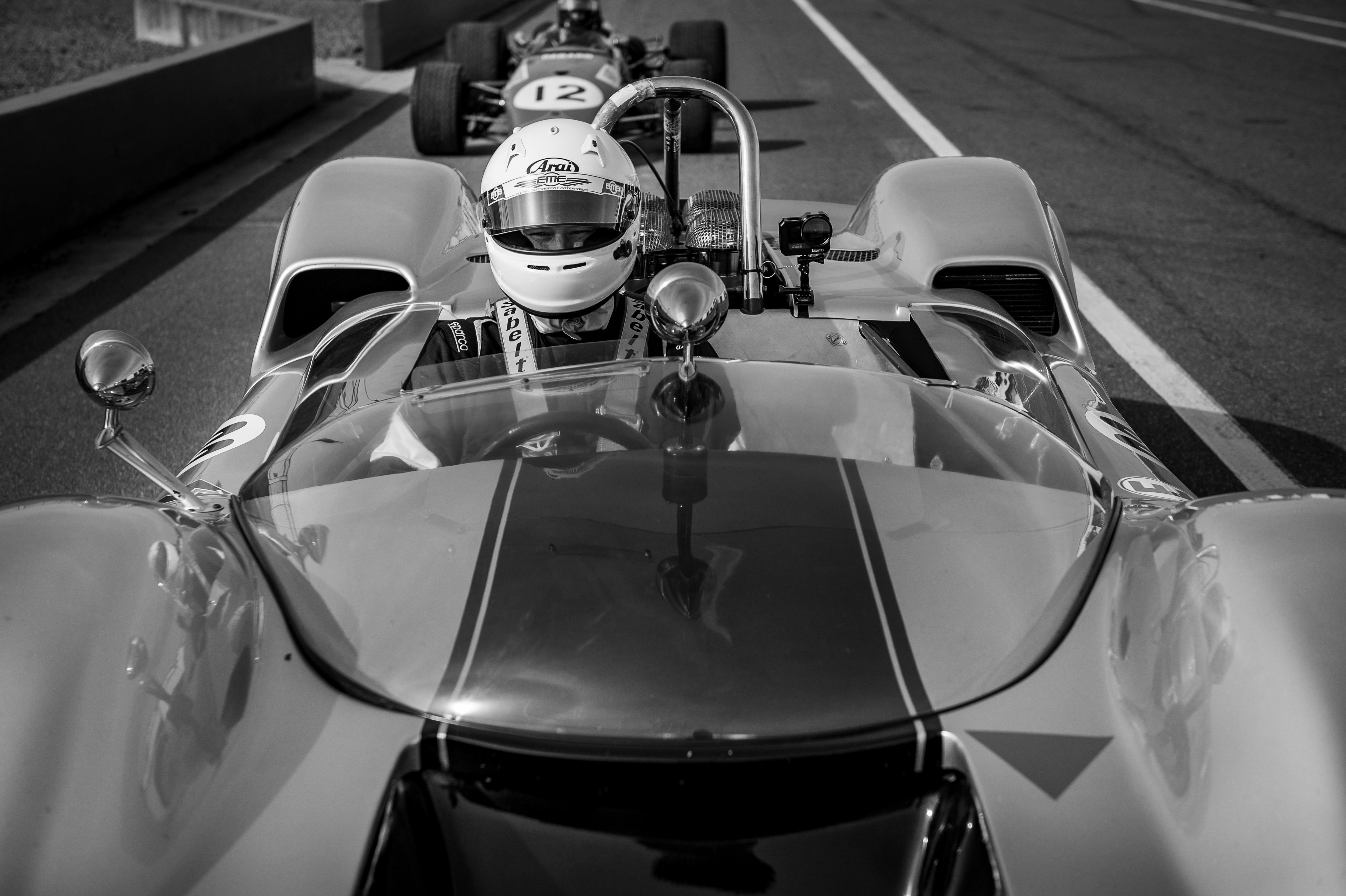 black and white Photo of a racing driver in an open wheeler