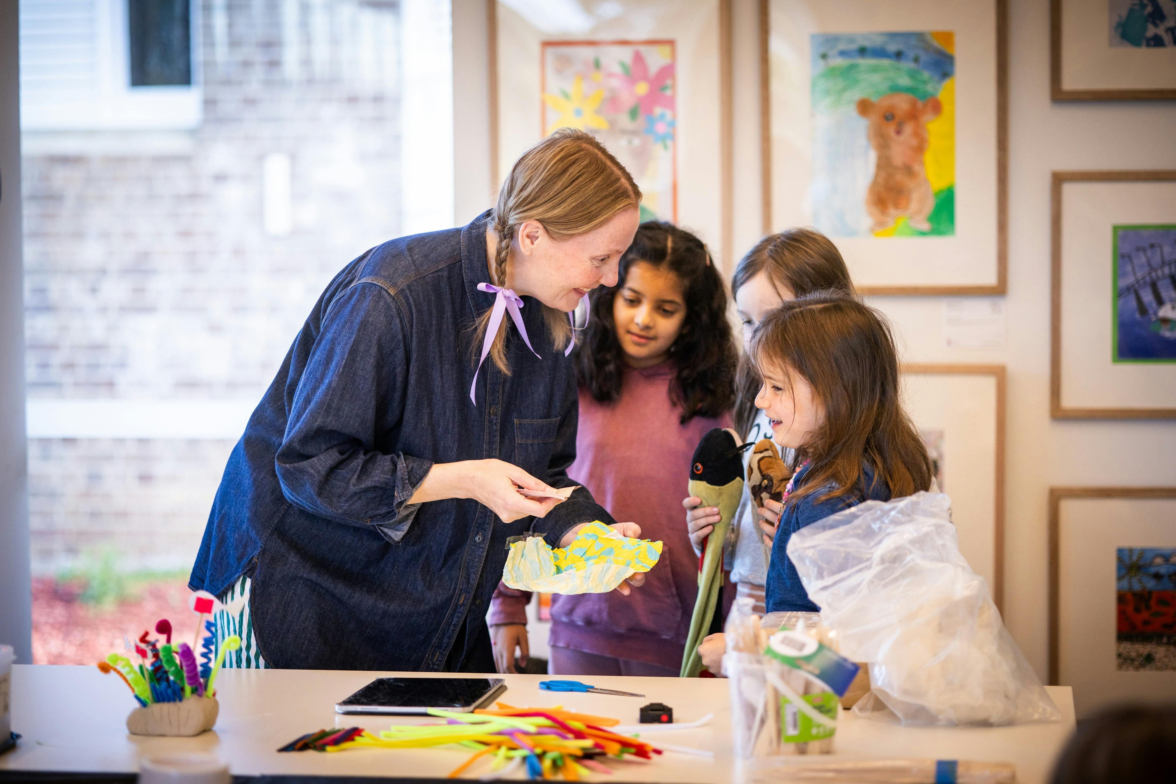 Woman talking to three children