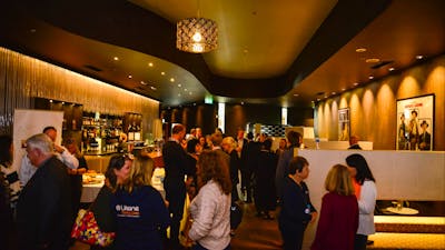 Patrons gather in the premium lounge bar before a movie
