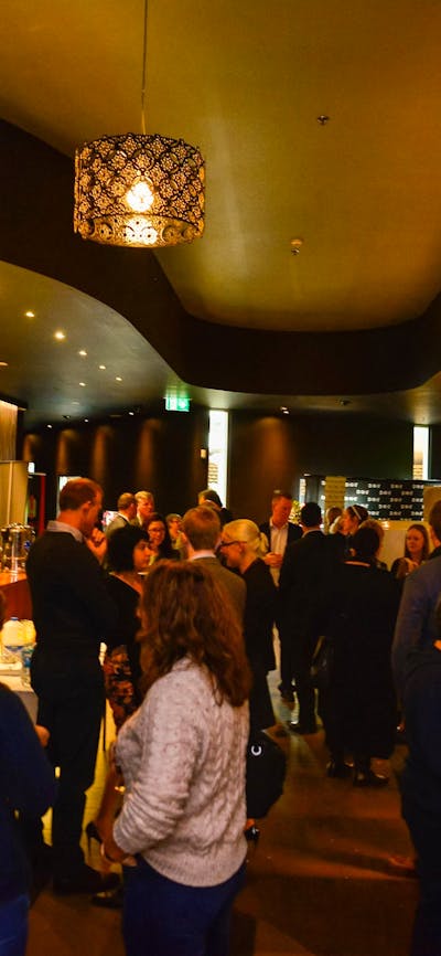 Patrons gather in the premium lounge bar before a movie