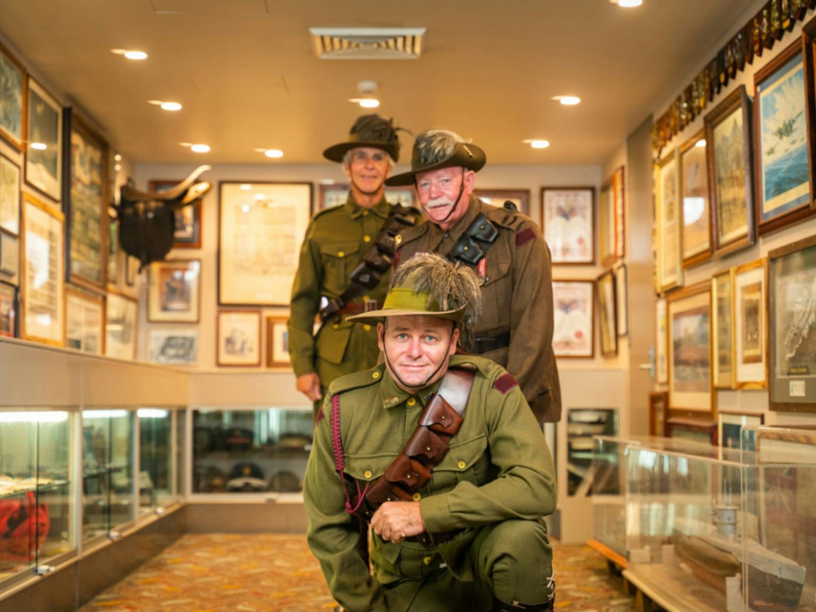 3 soldiers looking towards the camera inside the gallery