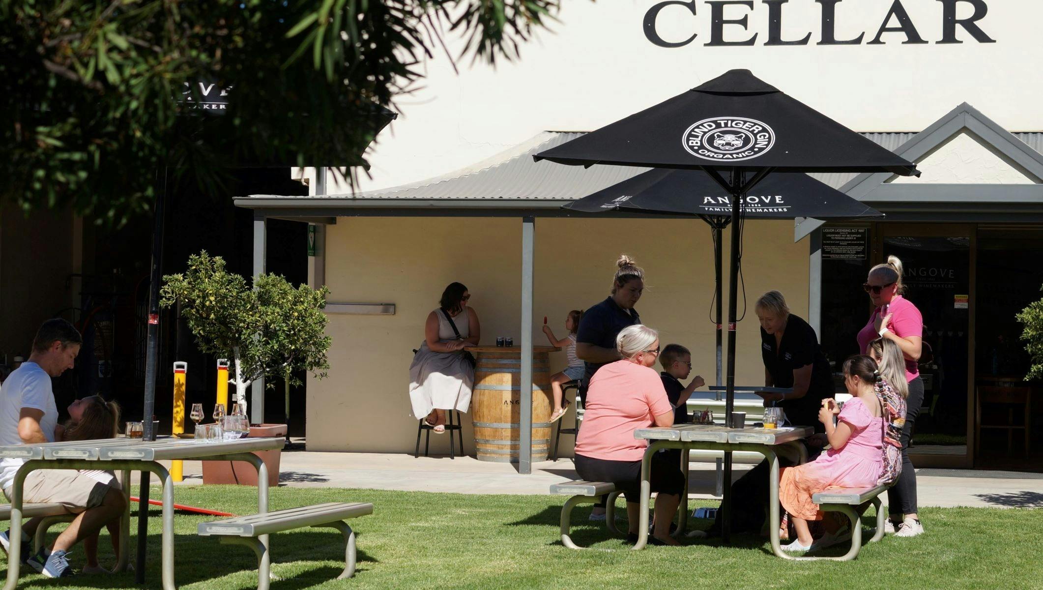 People sitting out the front of Angove cellar door