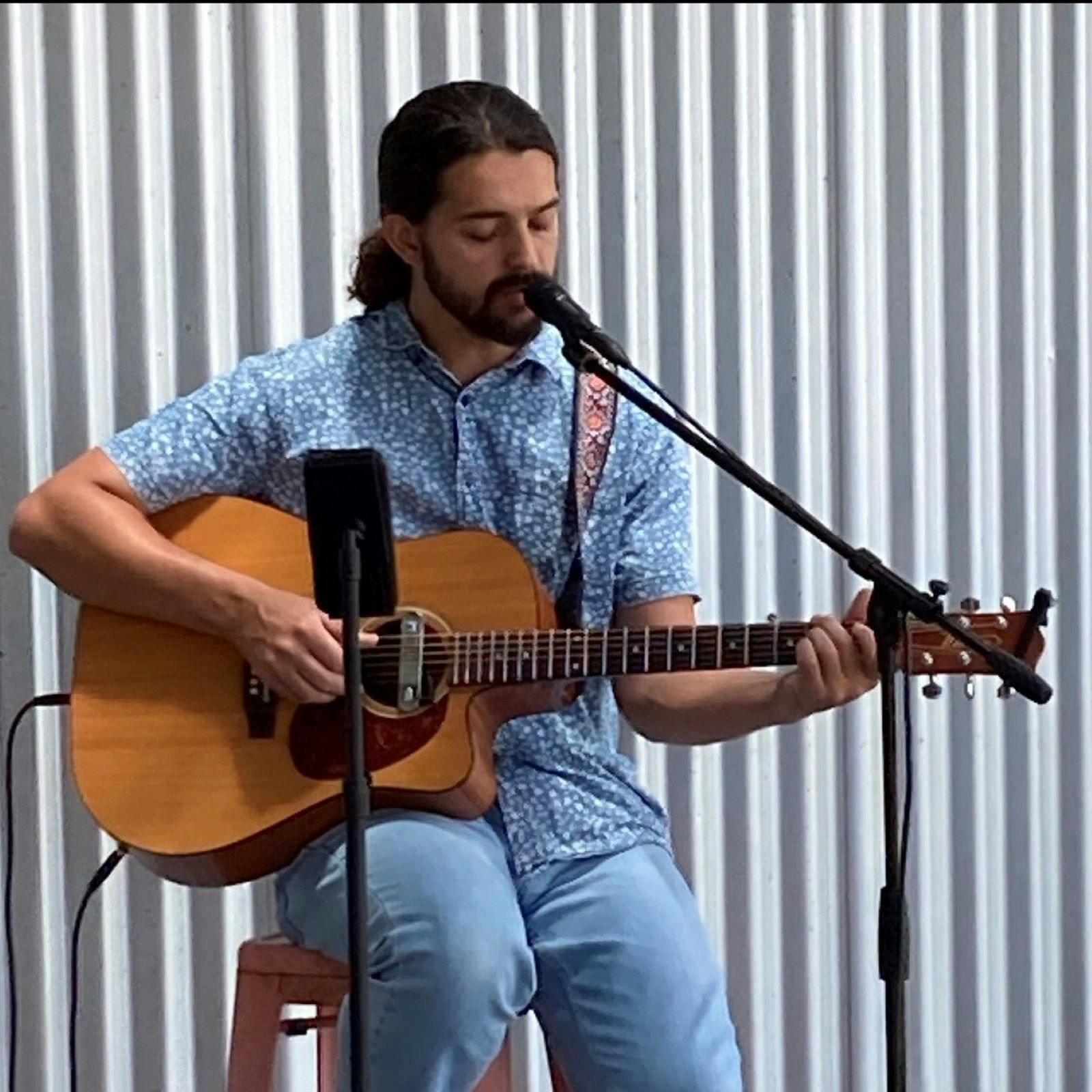 Man with guitar on deck
