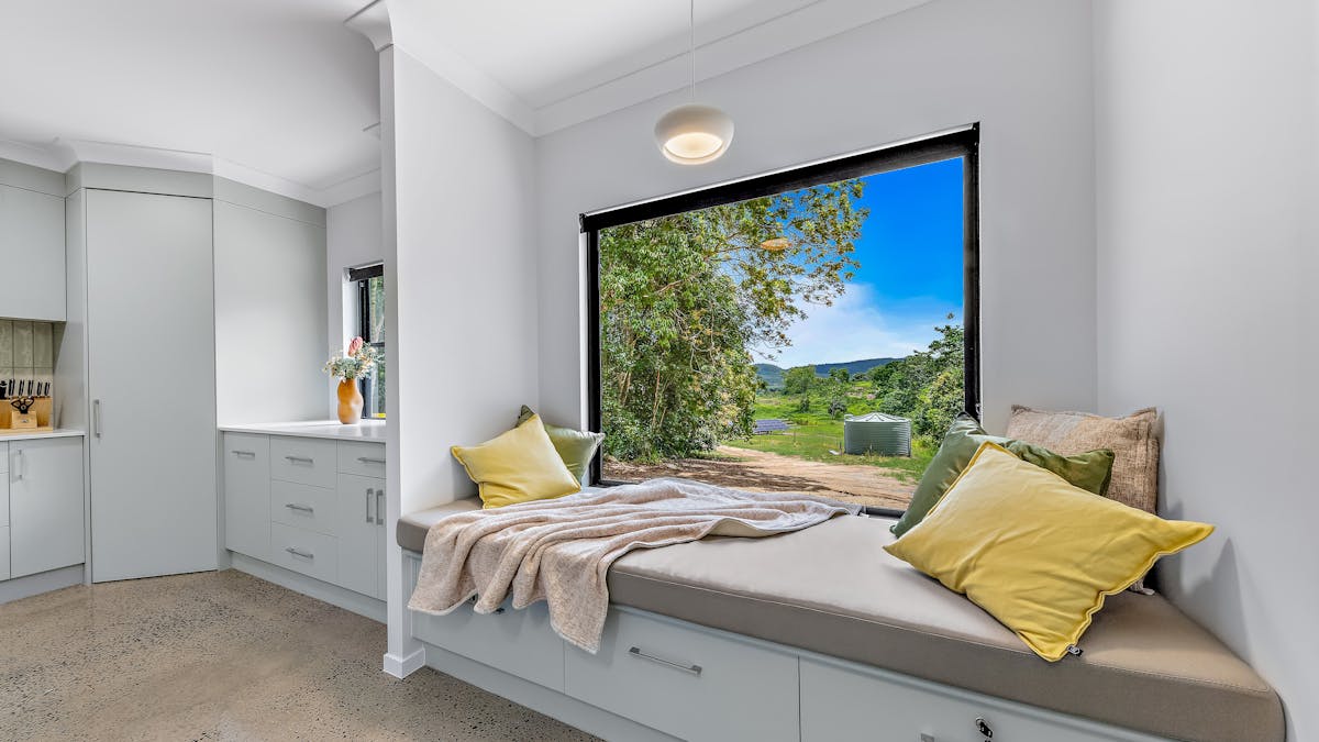 Day bed with cushions and throw, plus the outside view.