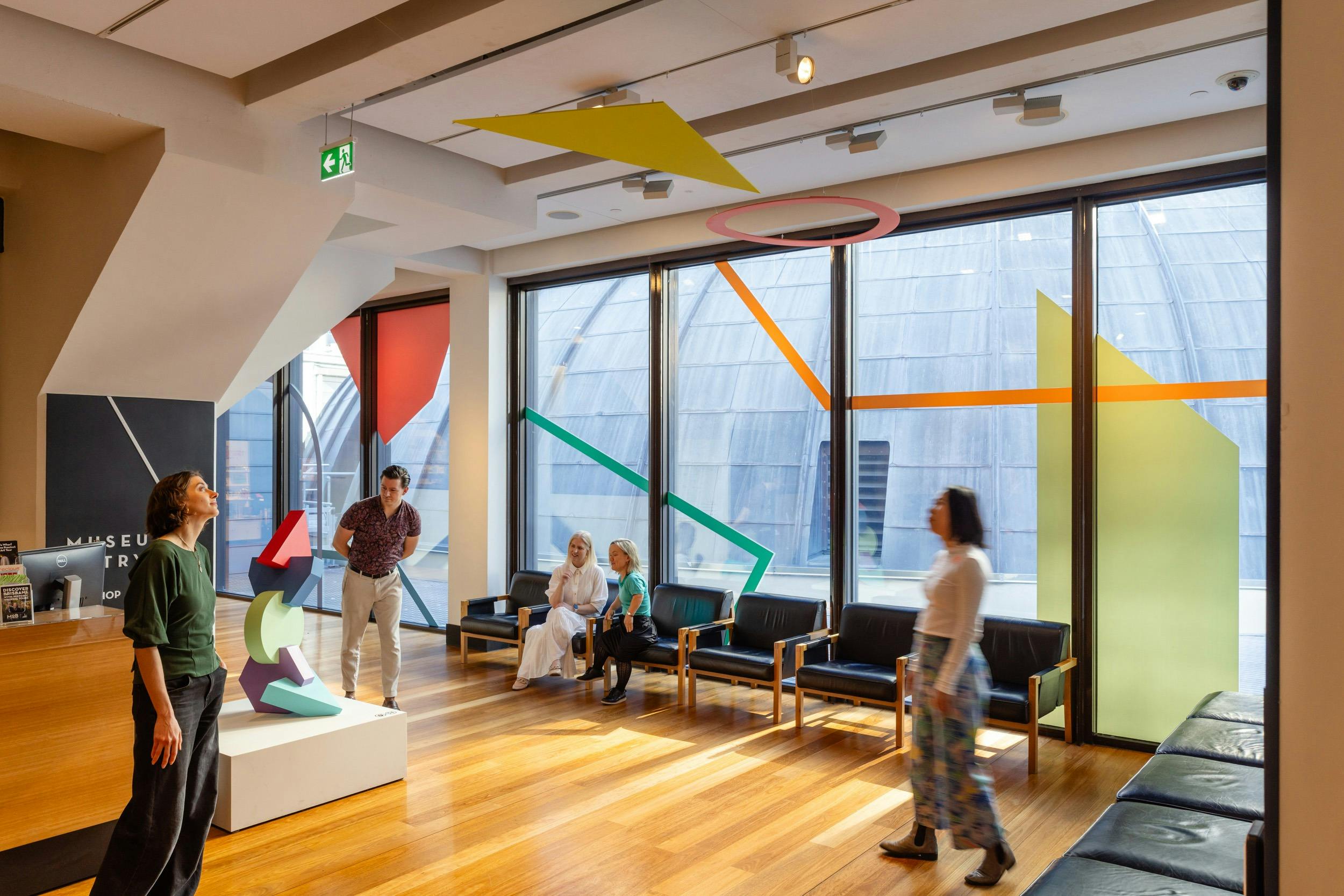 Visitors at the entrance of Museum of Brisbane. Features colourful shapes from Renee Kire.