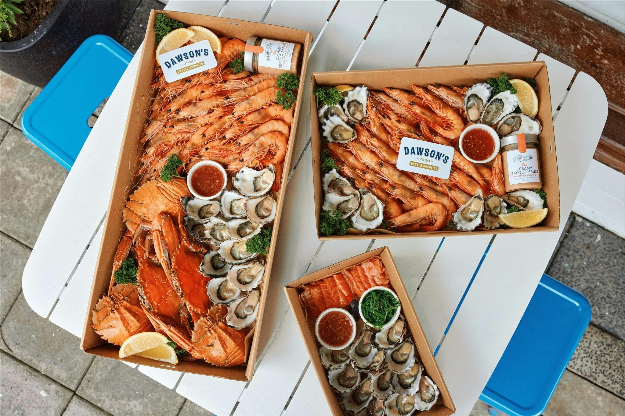 Three seafood platters on a white table