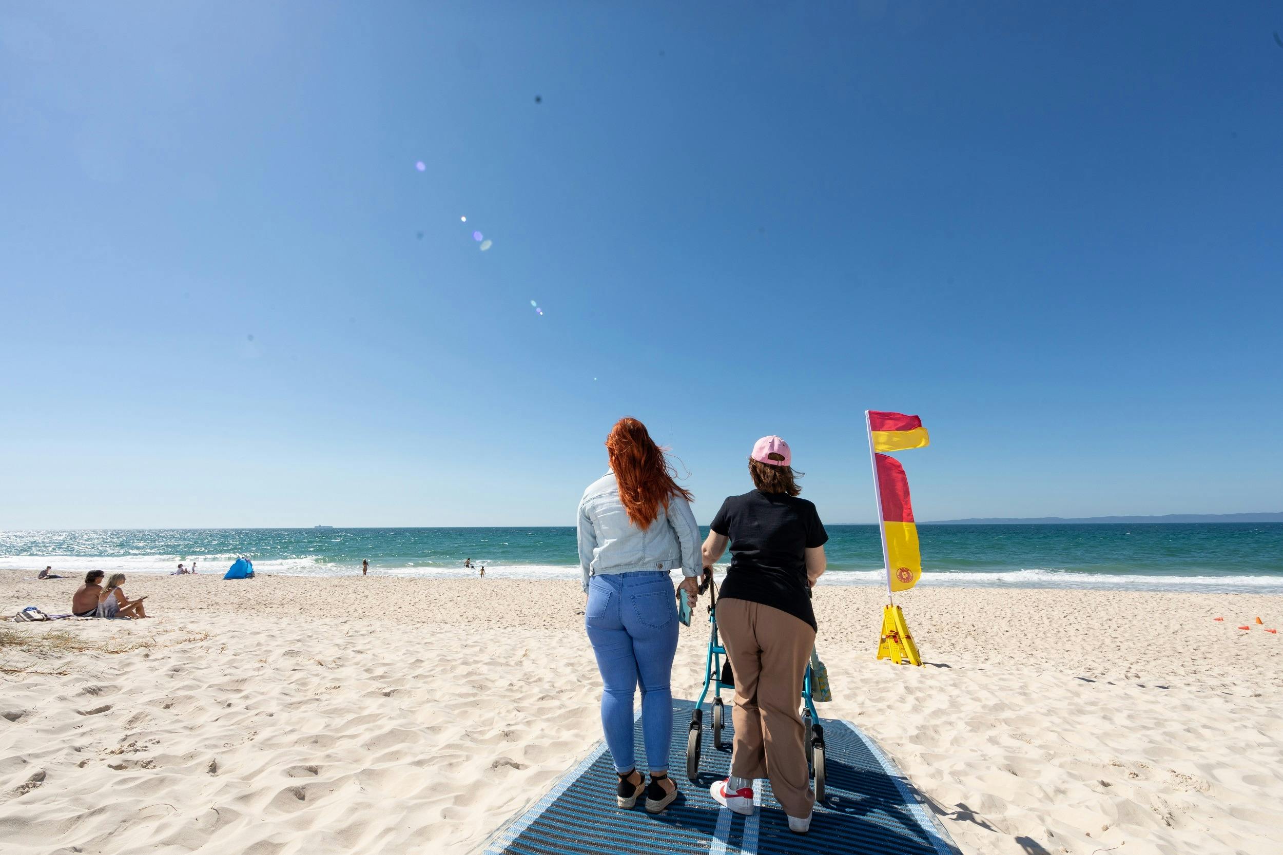 People walking along beach mat at Woorim Beach, Bribie Island