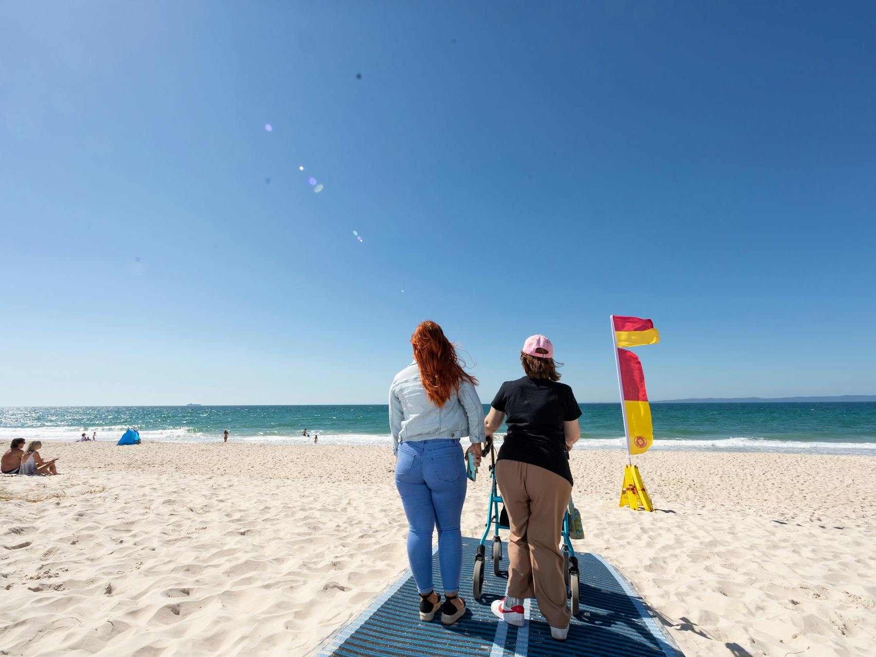 People walking along beach mat at Woorim Beach, Bribie Island