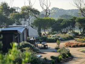 Cabins and tents situated in designed gardens.