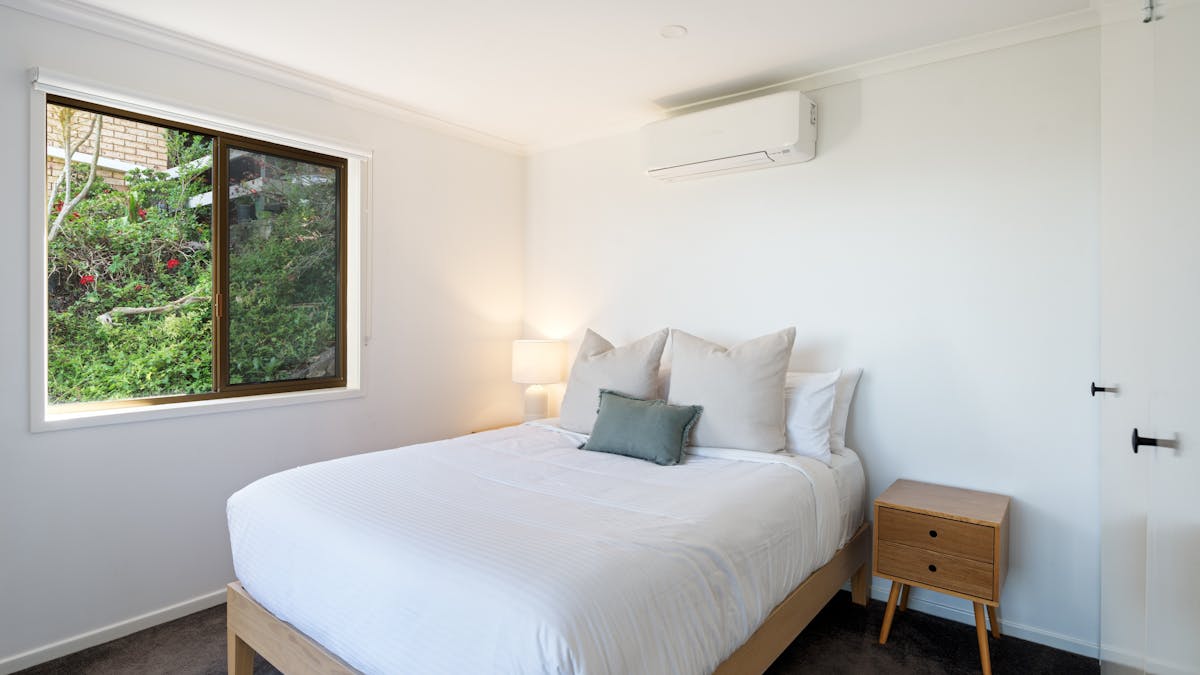 Wake up to picturesque views of lush trees right outside your bedroom windows