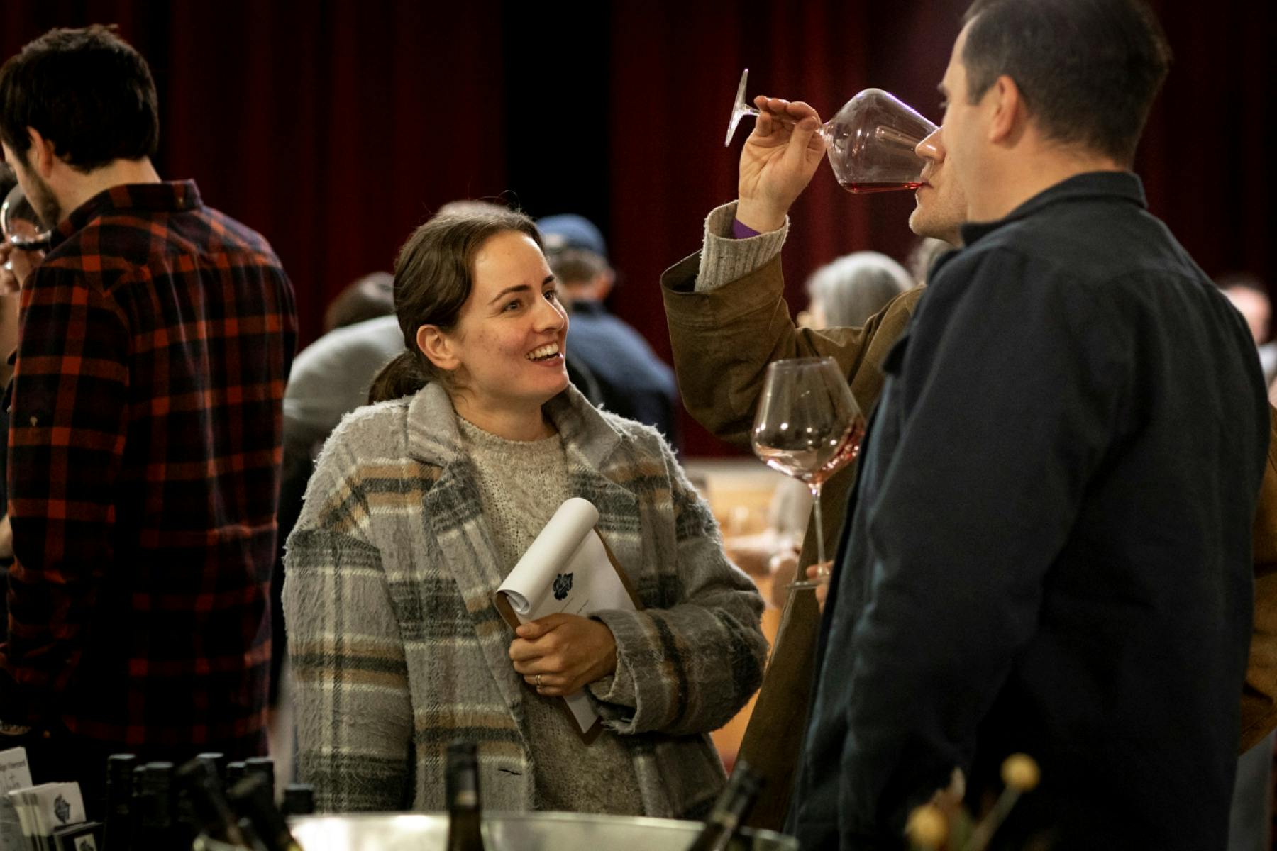 woman smiling and man drinking wine