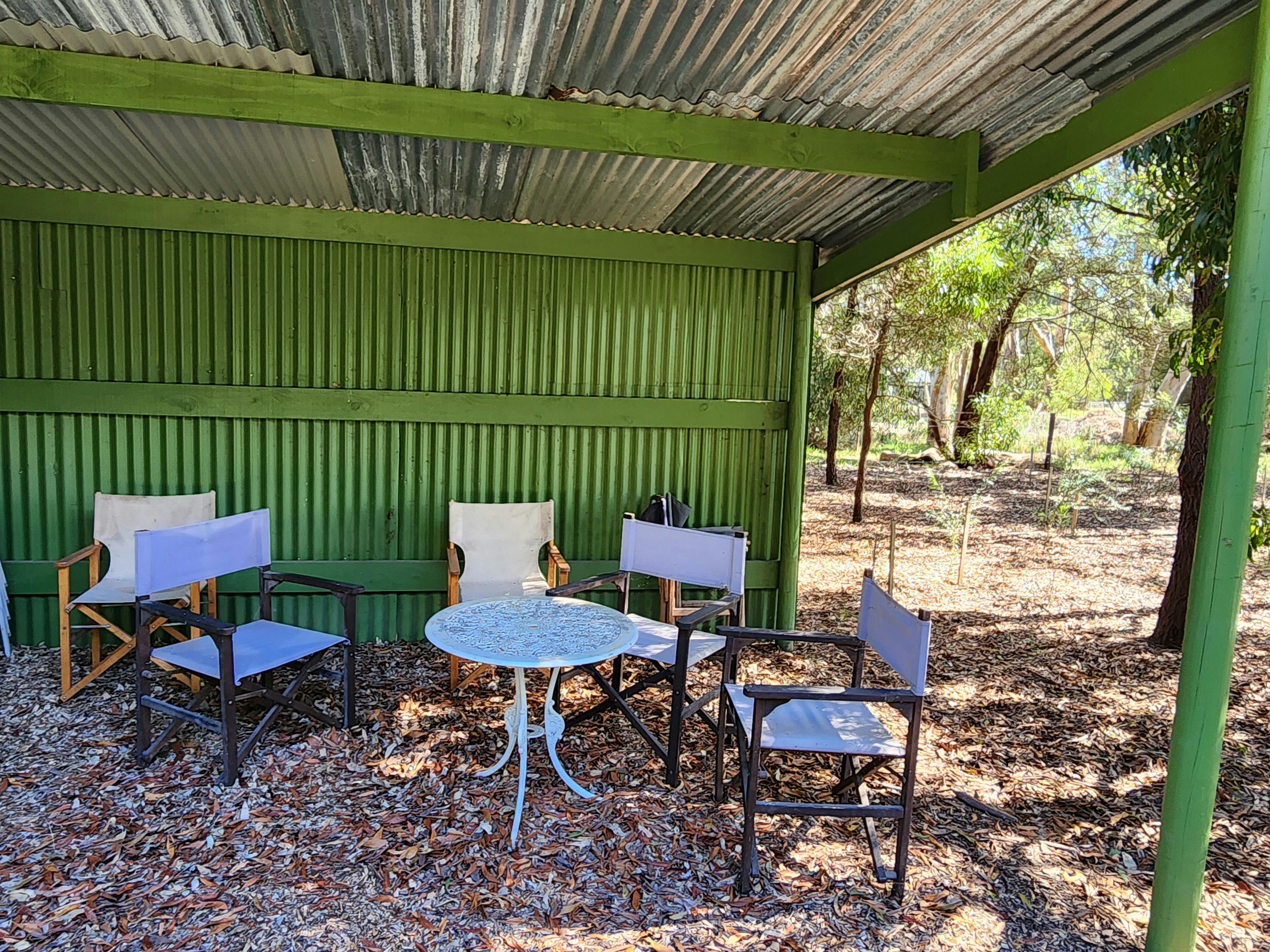 Tables and chairs in the sheltered, communal picnic area.