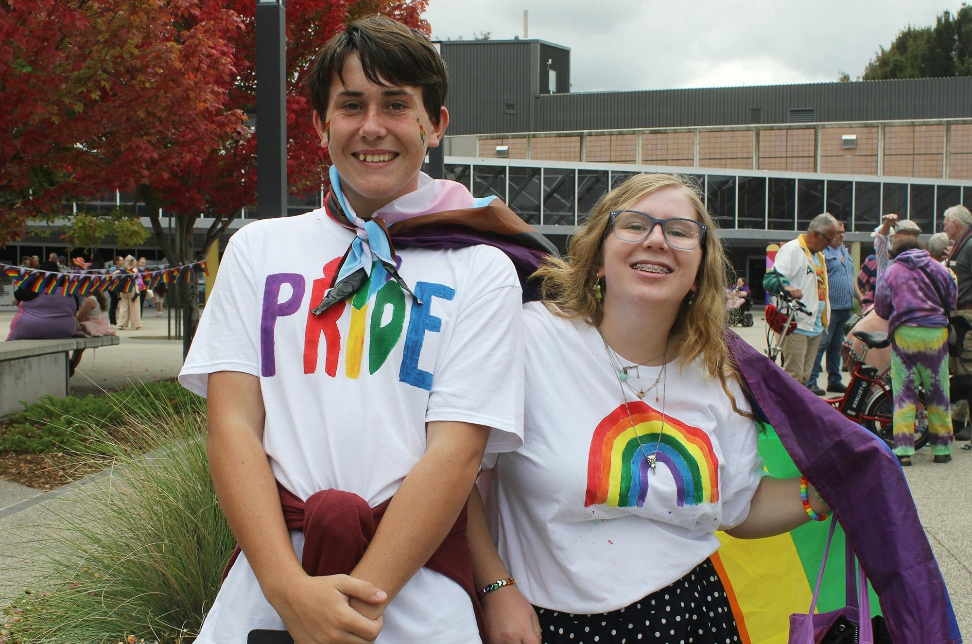 Two people wearing Pride t-shirts.