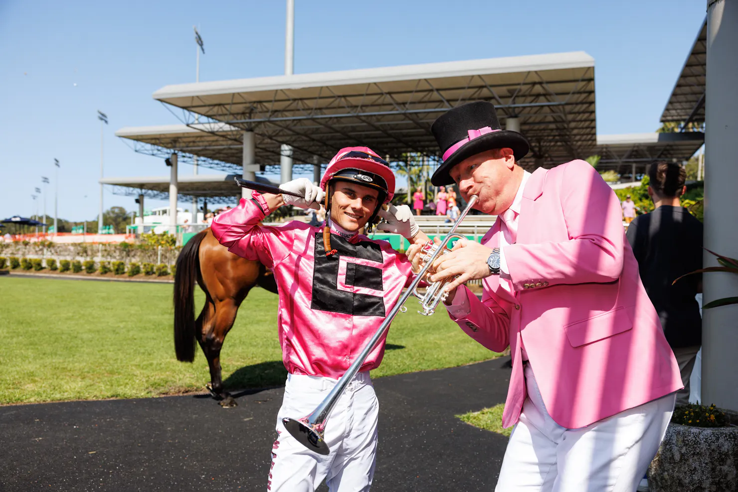 Jockey and bugler in the mounting yard dressed in pink